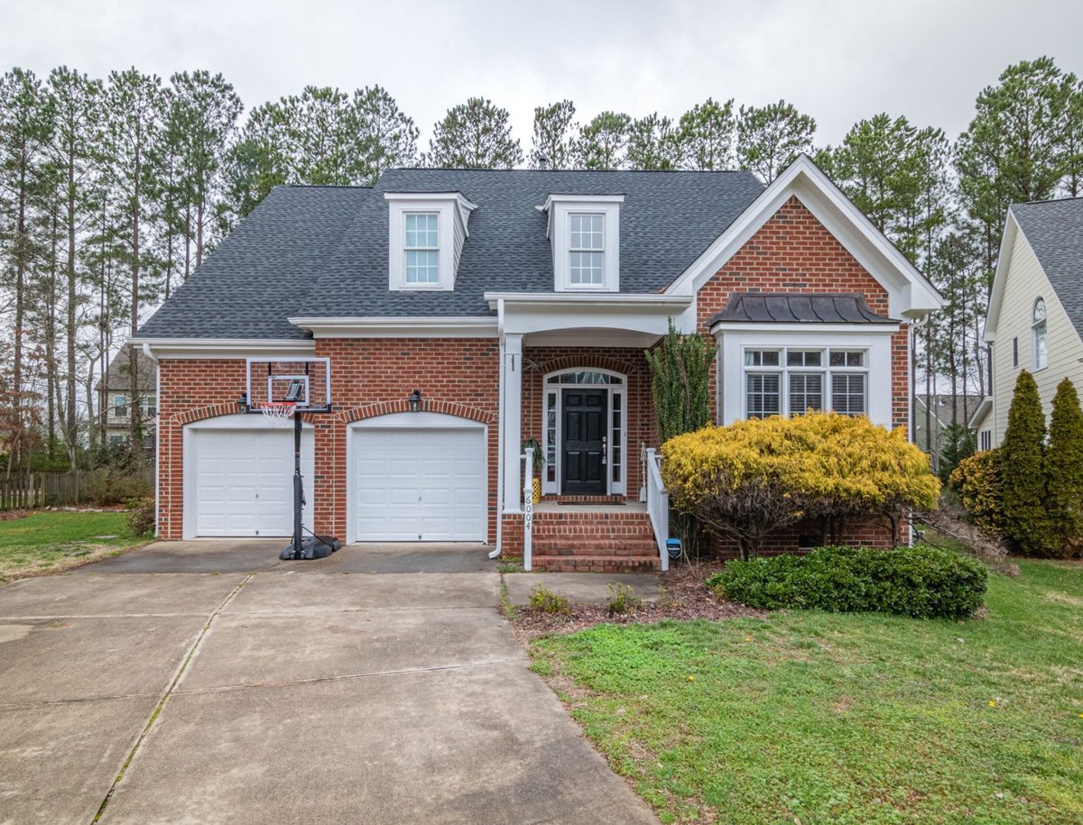 Clean brick home exterior with a freshly washed driveway in Fayetteville, NC